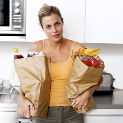 Young Woman Holding Two Brown Paper Grocery Bags